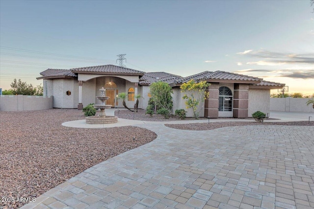 9183 W Shamel Ash Rd, Peoria, AZ 85383 - mediterranean / spanish house with stucco siding, curved driveway, and a tiled roof