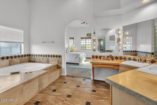 9183 W Shamel Ash Rd, Peoria, AZ 85383 - bathroom with a bath, vanity, ensuite bathroom, and a towering ceiling