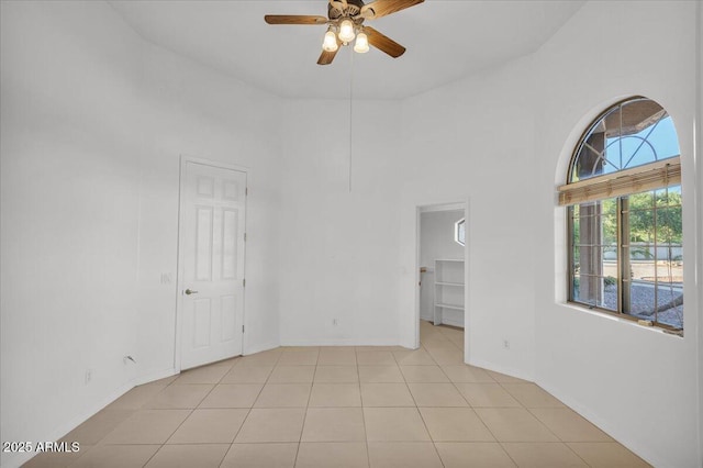 9183 W Shamel Ash Rd, Peoria, AZ 85383 - spare room with ceiling fan, a towering ceiling, and light tile patterned floors