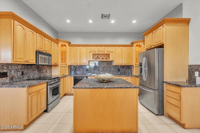 9183 W Shamel Ash Rd, Peoria, AZ 85383 - kitchen with black appliances, light tile patterned flooring, a kitchen island, dark stone counters, and recessed lighting