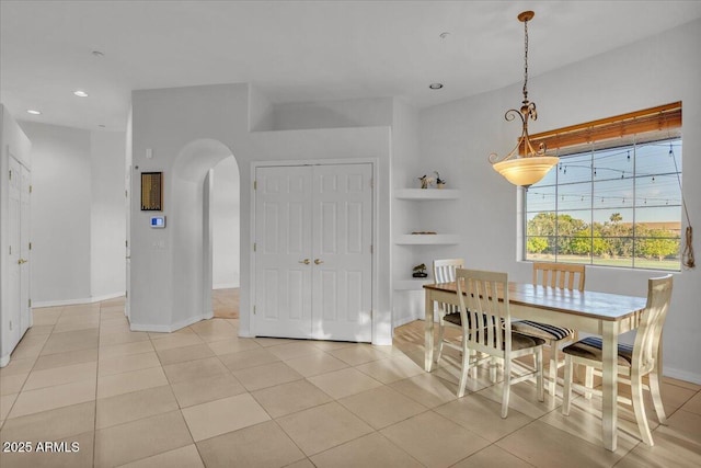 9183 W Shamel Ash Rd, Peoria, AZ 85383 - dining space with arched walkways, recessed lighting, light tile patterned flooring, and built in features