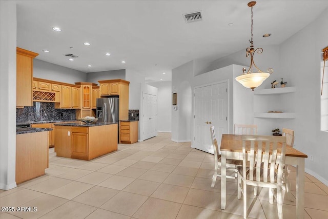 9183 W Shamel Ash Rd, Peoria, AZ 85383 - kitchen with stainless steel fridge, a kitchen island, backsplash, light tile patterned floors, and recessed lighting
