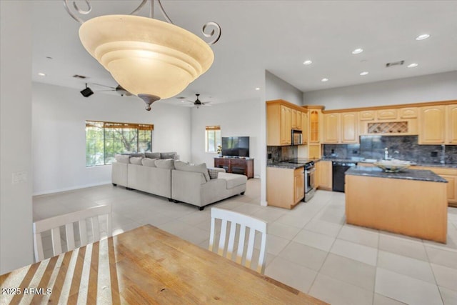 9183 W Shamel Ash Rd, Peoria, AZ 85383 - kitchen featuring stainless steel appliances, open floor plan, light tile patterned flooring, light brown cabinets, and backsplash