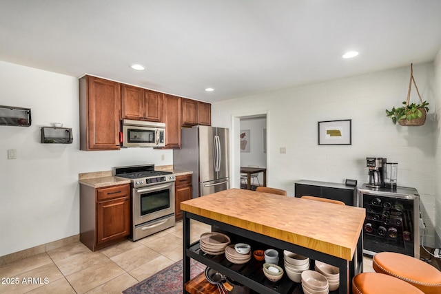 844 E Ruth Ave, Phoenix, AZ 85020 - kitchen with appliances with stainless steel finishes, light tile patterned flooring, recessed lighting, light countertops, and baseboards
