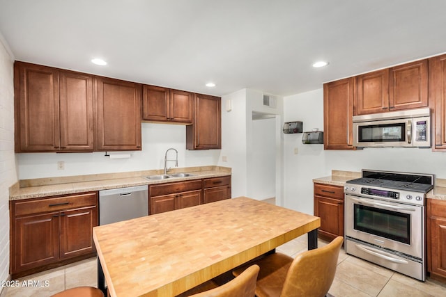 844 E Ruth Ave, Phoenix, AZ 85020 - kitchen with stainless steel appliances, a sink, light tile patterned floors, recessed lighting, and light countertops