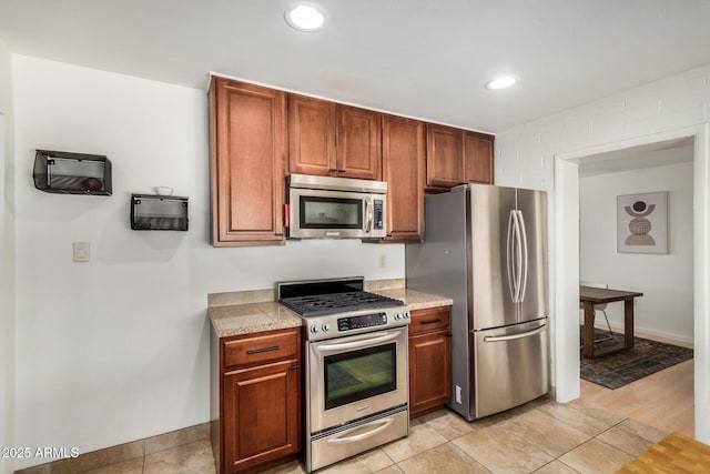 844 E Ruth Ave, Phoenix, AZ 85020 - kitchen featuring stainless steel appliances, baseboards, recessed lighting, brown cabinetry, and light tile patterned floors