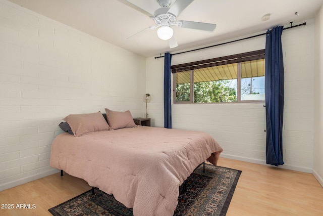844 E Ruth Ave, Phoenix, AZ 85020 - bedroom featuring wood finished floors, concrete block wall, and a ceiling fan