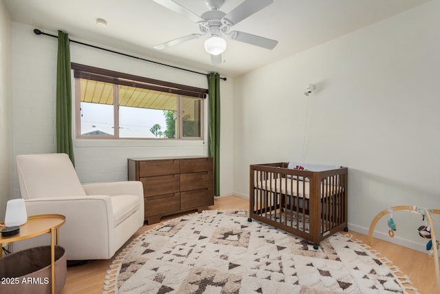 844 E Ruth Ave, Phoenix, AZ 85020 - bedroom featuring light wood-type flooring, a nursery area, baseboards, and a ceiling fan