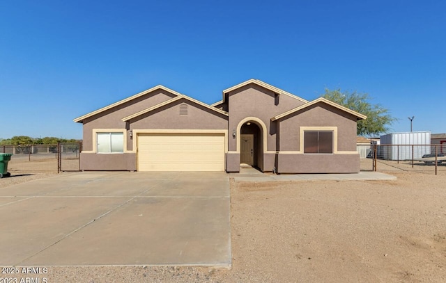 ranch-style house with driveway, a garage, fence, and stucco siding