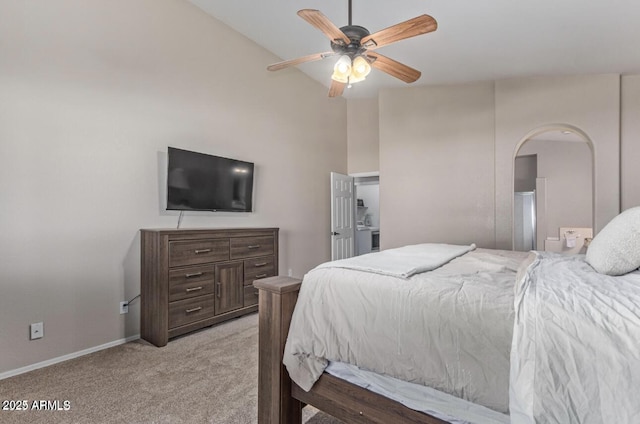 bedroom with arched walkways, light colored carpet, ceiling fan, and baseboards