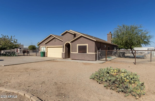 ranch-style house featuring a chimney, stucco siding, concrete driveway, fence, and a garage