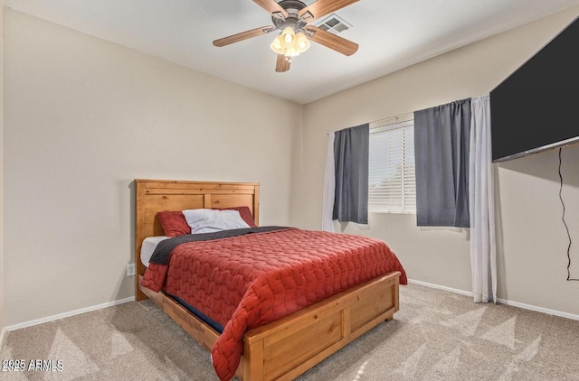 carpeted bedroom featuring a ceiling fan, visible vents, and baseboards