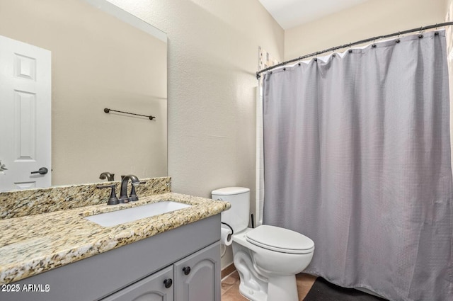 bathroom featuring toilet, a shower with shower curtain, and vanity