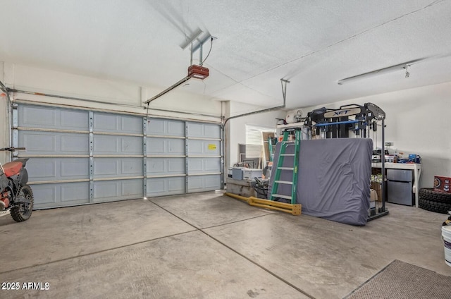 garage with a garage door opener and freestanding refrigerator