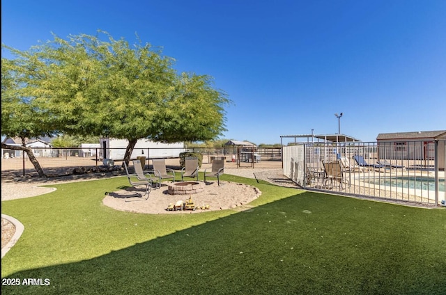 view of yard featuring a patio, an outdoor fire pit, fence, and a fenced in pool