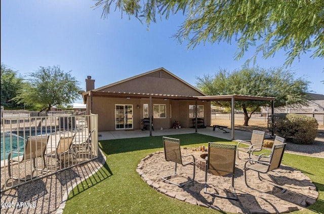 rear view of property with a patio, fence, and stucco siding