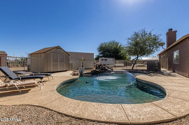 view of pool featuring a fenced in pool, a fenced backyard, an outbuilding, a storage unit, and a patio area