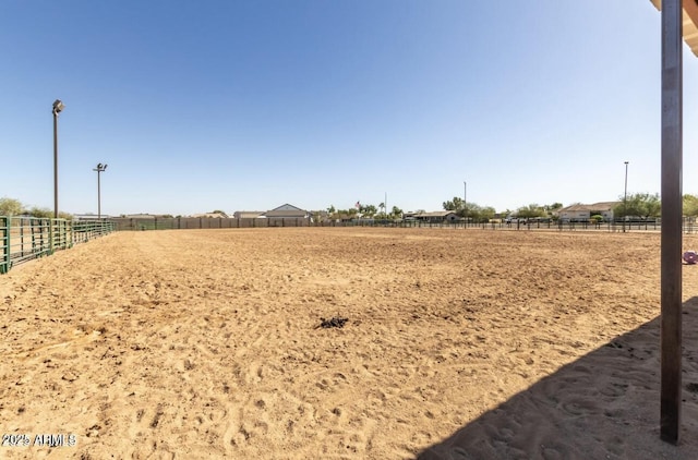 view of yard featuring an enclosed area and a rural view