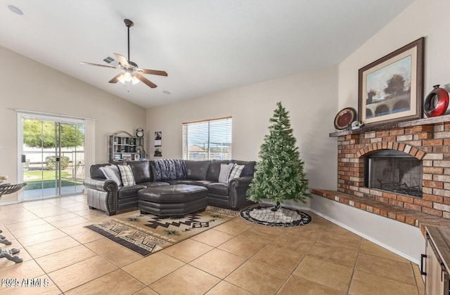 tiled living area with lofted ceiling, ceiling fan, plenty of natural light, and a brick fireplace