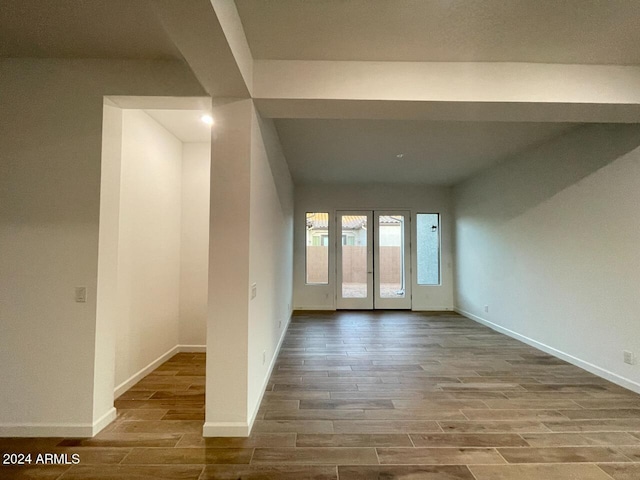 spare room featuring french doors and hardwood / wood-style floors