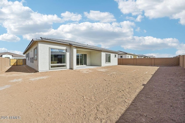 rear view of house with a patio