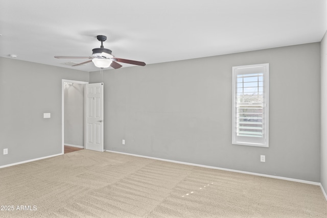 unfurnished room featuring light colored carpet and ceiling fan