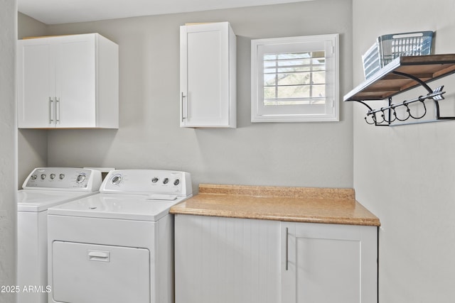 clothes washing area with cabinets and independent washer and dryer