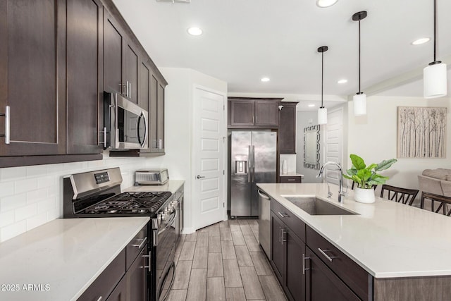 2250 E Palmdale Ln, Gilbert, AZ 85298 - kitchen featuring stainless steel appliances, a sink, a center island with sink, dark brown cabinets, and recessed lighting