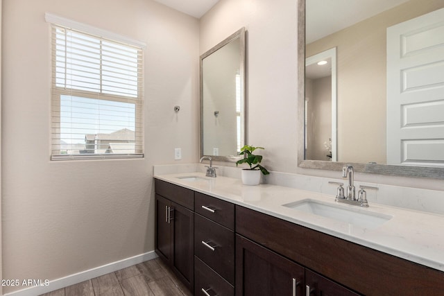 2250 E Palmdale Ln, Gilbert, AZ 85298 - bathroom with wood finished floors, double vanity, and baseboards