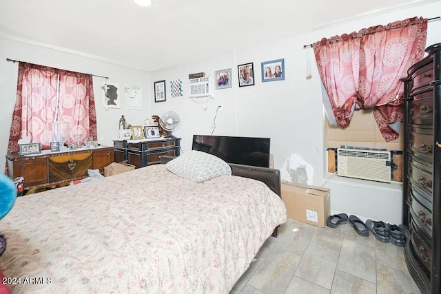 bedroom with an AC wall unit, cooling unit, and light tile patterned flooring