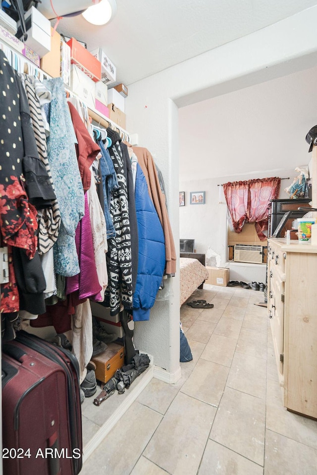 spacious closet with light tile patterned floors