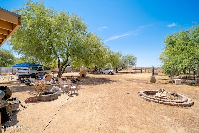 view of yard with an outdoor fire pit