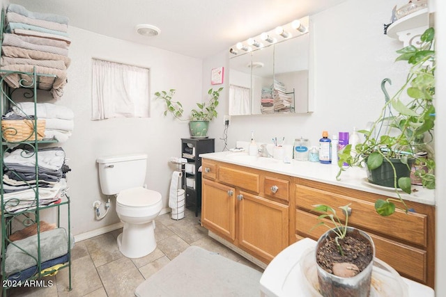 bathroom featuring vanity and toilet