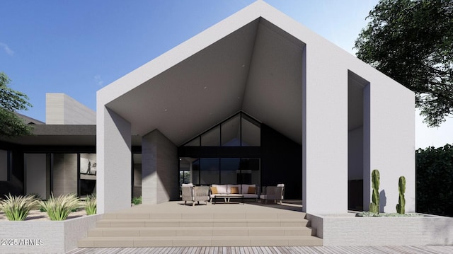 back of house with outdoor lounge area and a patio