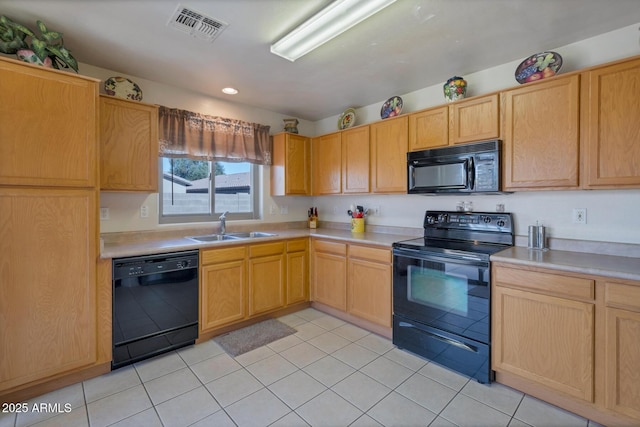 kitchen with black appliances, light brown cabinets, light tile patterned floors, and sink