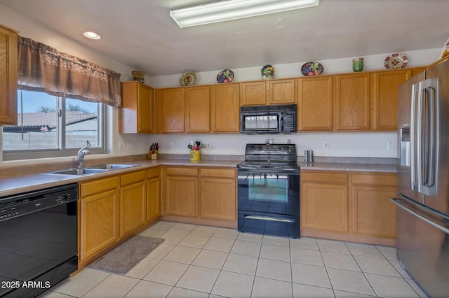 kitchen with light tile patterned floors, sink, and black appliances