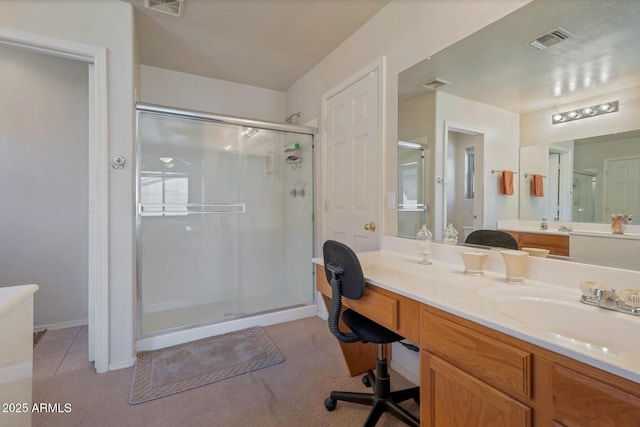 bathroom featuring tile patterned flooring, vanity, and an enclosed shower