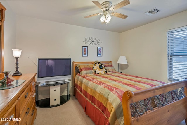 bedroom featuring ceiling fan and light colored carpet