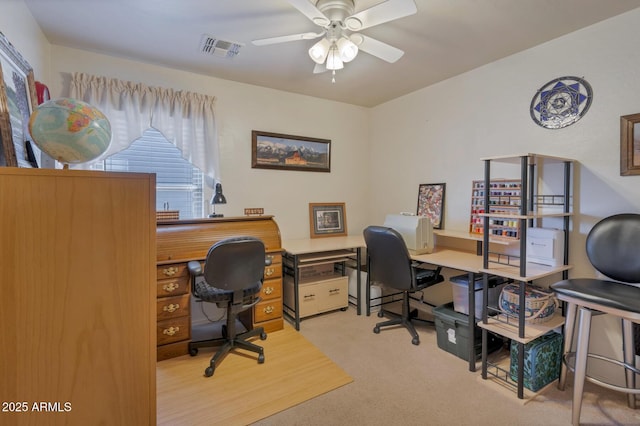 home office featuring ceiling fan and light colored carpet