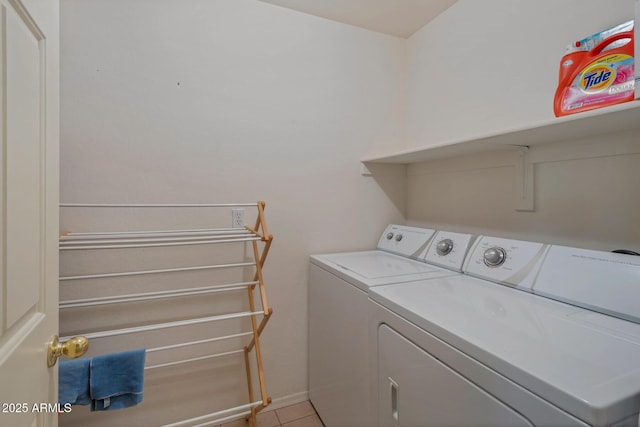 laundry area with washer and dryer and light tile patterned floors