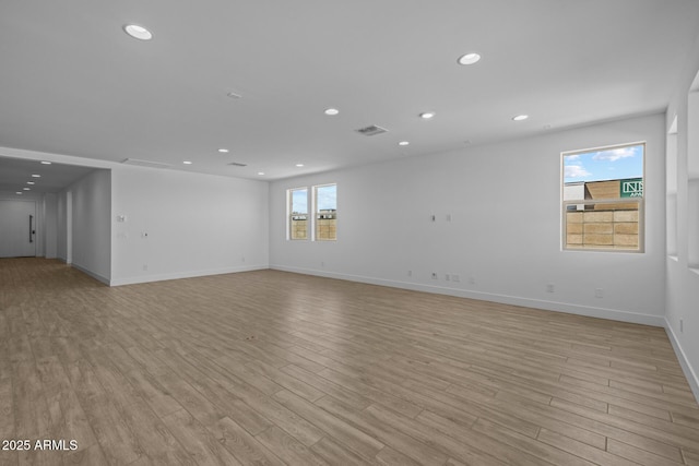 spare room featuring recessed lighting, light wood-style flooring, and visible vents