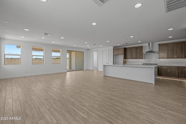 interior space featuring light wood-style floors, recessed lighting, and visible vents