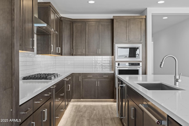 kitchen with gas cooktop, a sink, built in microwave, and recessed lighting