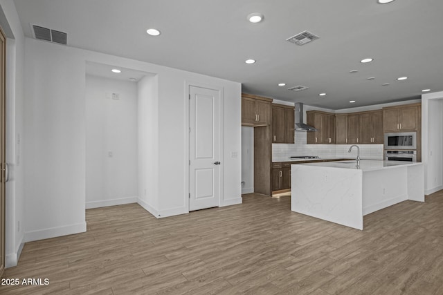 kitchen with visible vents, recessed lighting, appliances with stainless steel finishes, and wall chimney range hood