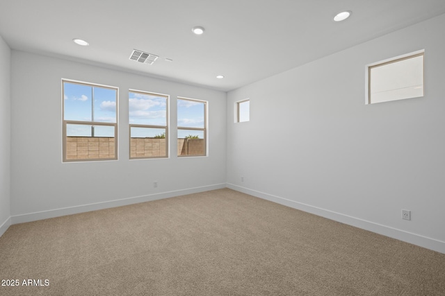 spare room with light colored carpet, visible vents, and recessed lighting