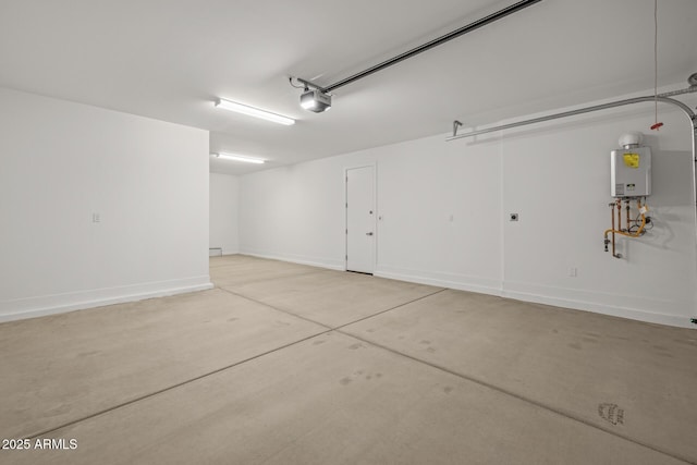 garage featuring baseboards, tankless water heater, and a garage door opener