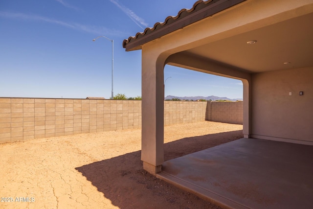view of patio featuring a fenced backyard and a mountain view