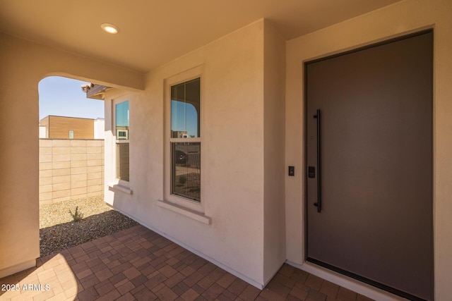doorway to property featuring a patio and stucco siding
