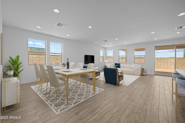 dining room with visible vents, baseboards, and wood finished floors