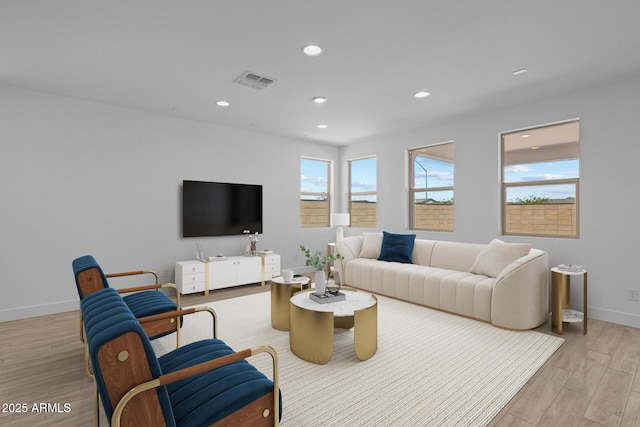 living room featuring recessed lighting, baseboards, light wood-type flooring, and visible vents